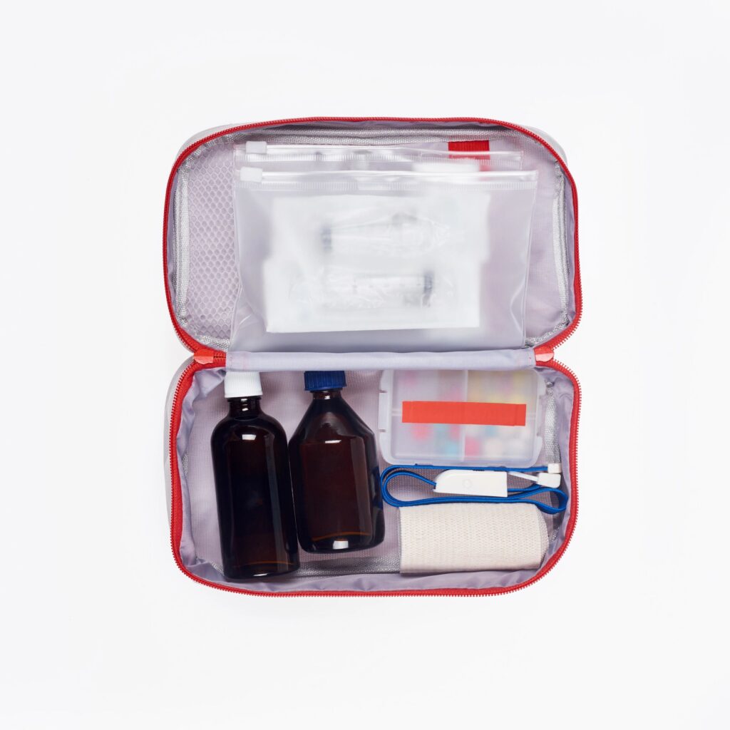 top view of automotive first aid kit with different medicines isolated on white