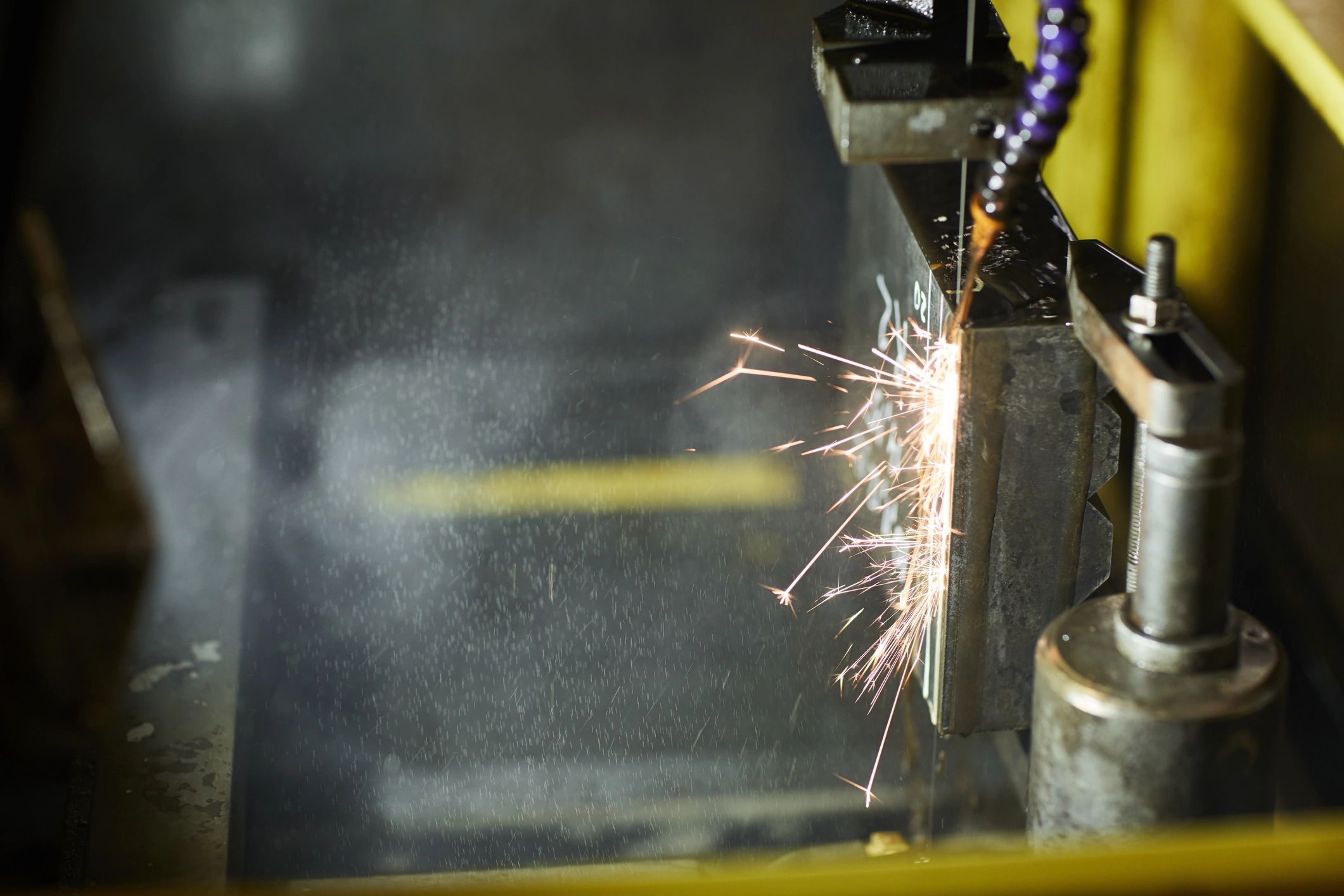 Close-up of precision electrical discharge machining shaping metal