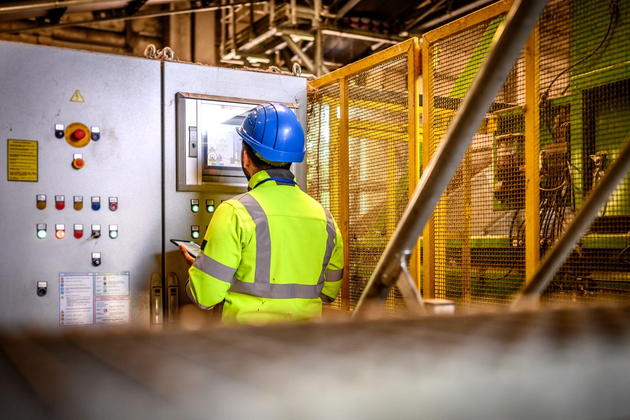 Machining operator monitoring industrial equipment